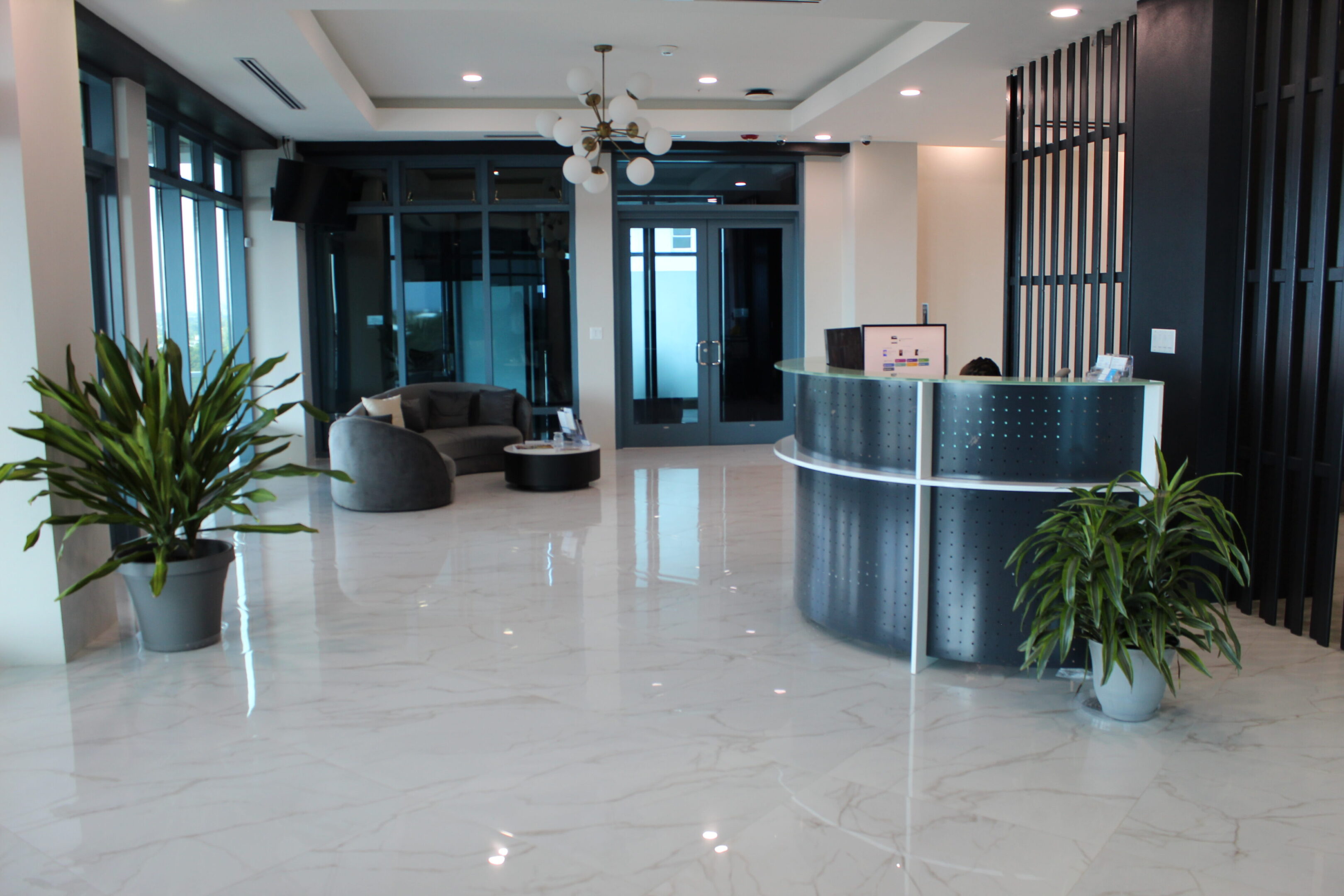 Modern office lobby with sleek furniture and polished floors.